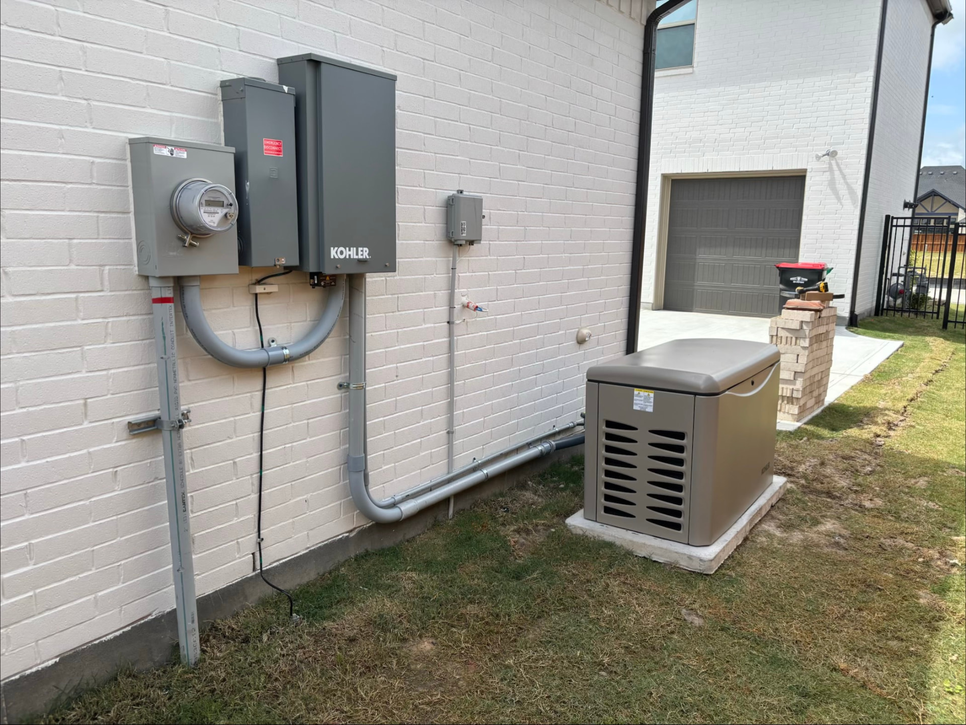 Kohler automatic transfer switch and meter with generator alongside a Texas home
